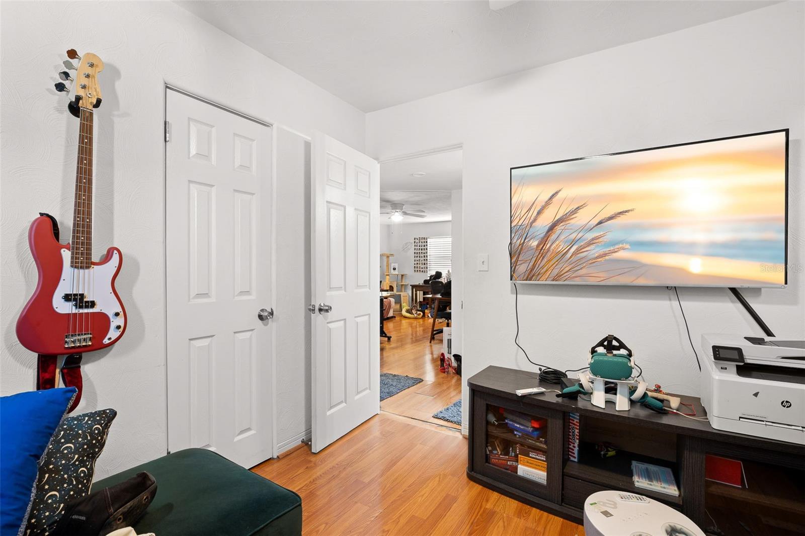 Comfortable second bedroom featuring wood-look flooring, natural light, and a flexible layout that easily adapts to a variety of uses.