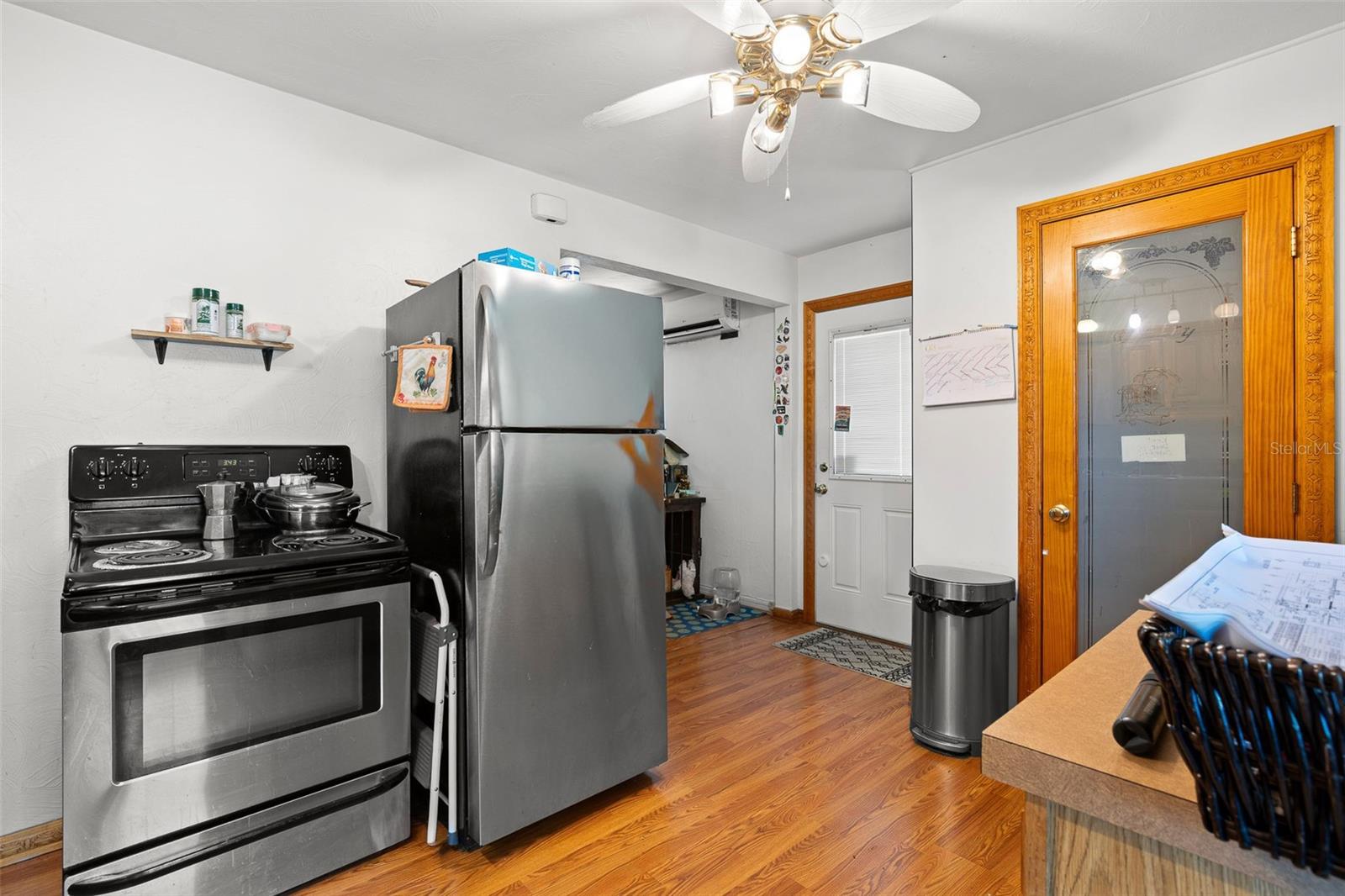 Kitchen features a practical layout with full-size stainless steel appliances, a walk-in pantry, and convenient access to the rear entry, supporting easy everyday use.