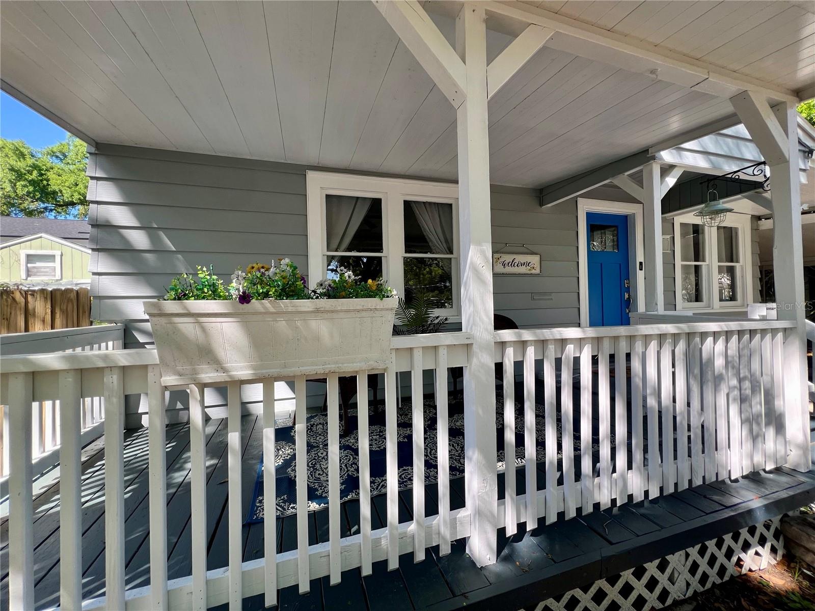 Your adorable front porch has just enough dappled sunlight to brighten your day.