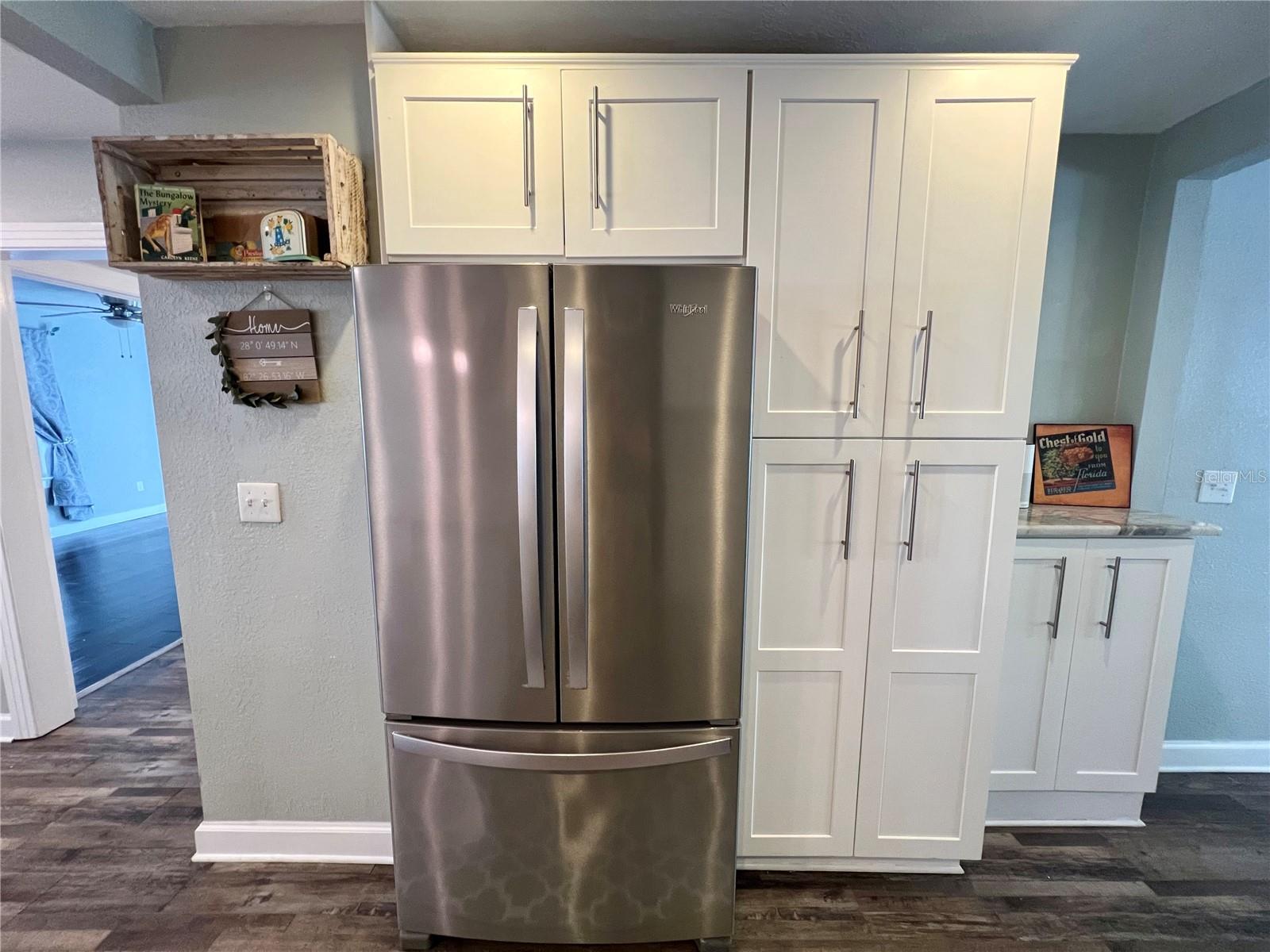 A stainless steel refrigerator and an ample pantry for all of your food prep needs