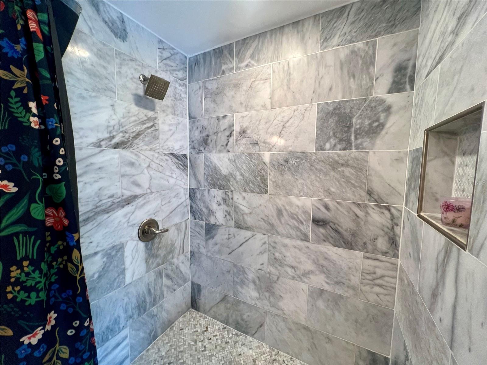 Granite tile in the shower compliments the vanity.
