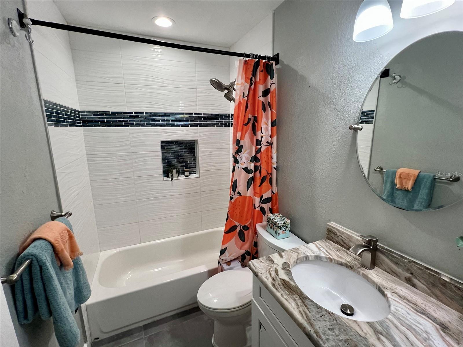 The second bathroom off the hallway is giving Florida sunshine vibes.