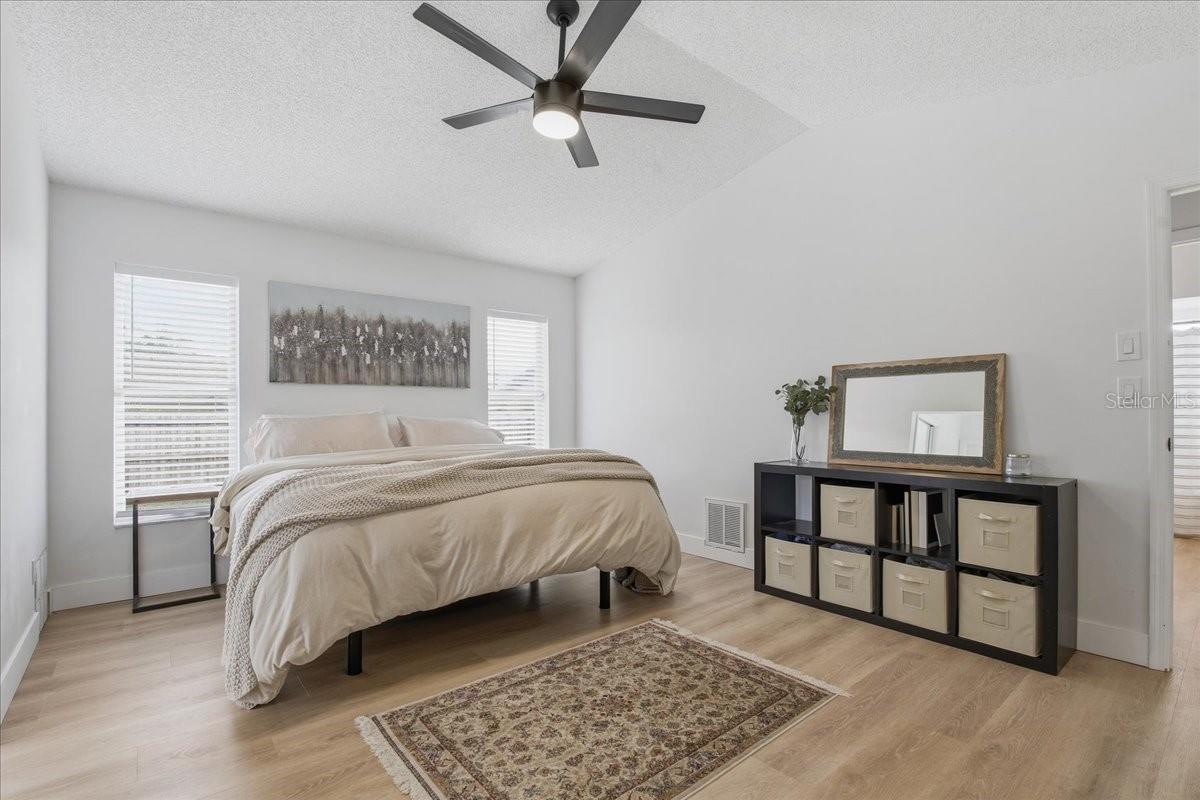 VAULTED CEILINGS CONTINUE INTO THE PRIMARY BEDROOM & LUXURY VINYL PLANK FLOORING THROUGHOUT!