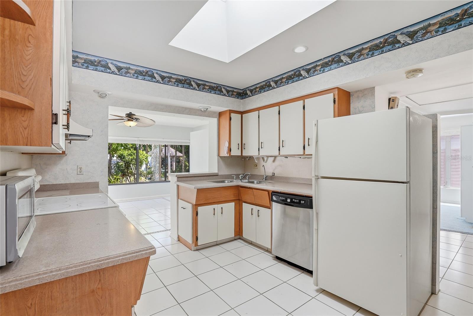 Appliances include refrigerator, dishwasher, microwave, hood, and range.