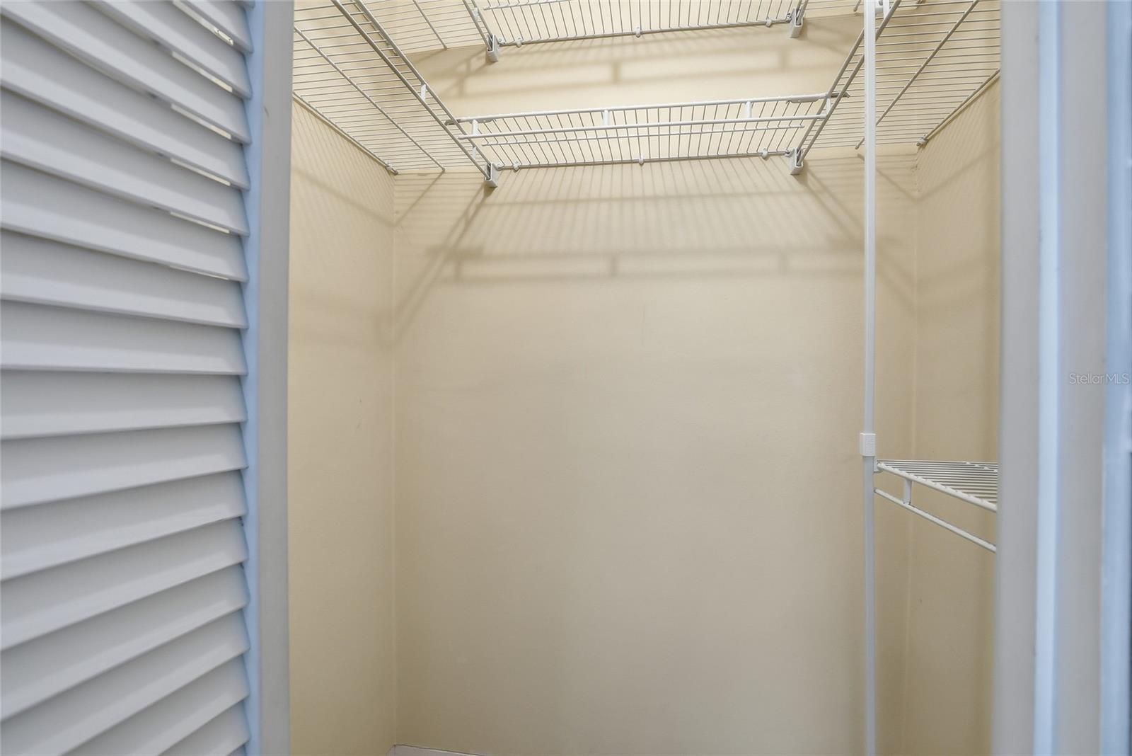 Walk-in closet includes installed wiring for added functionality.