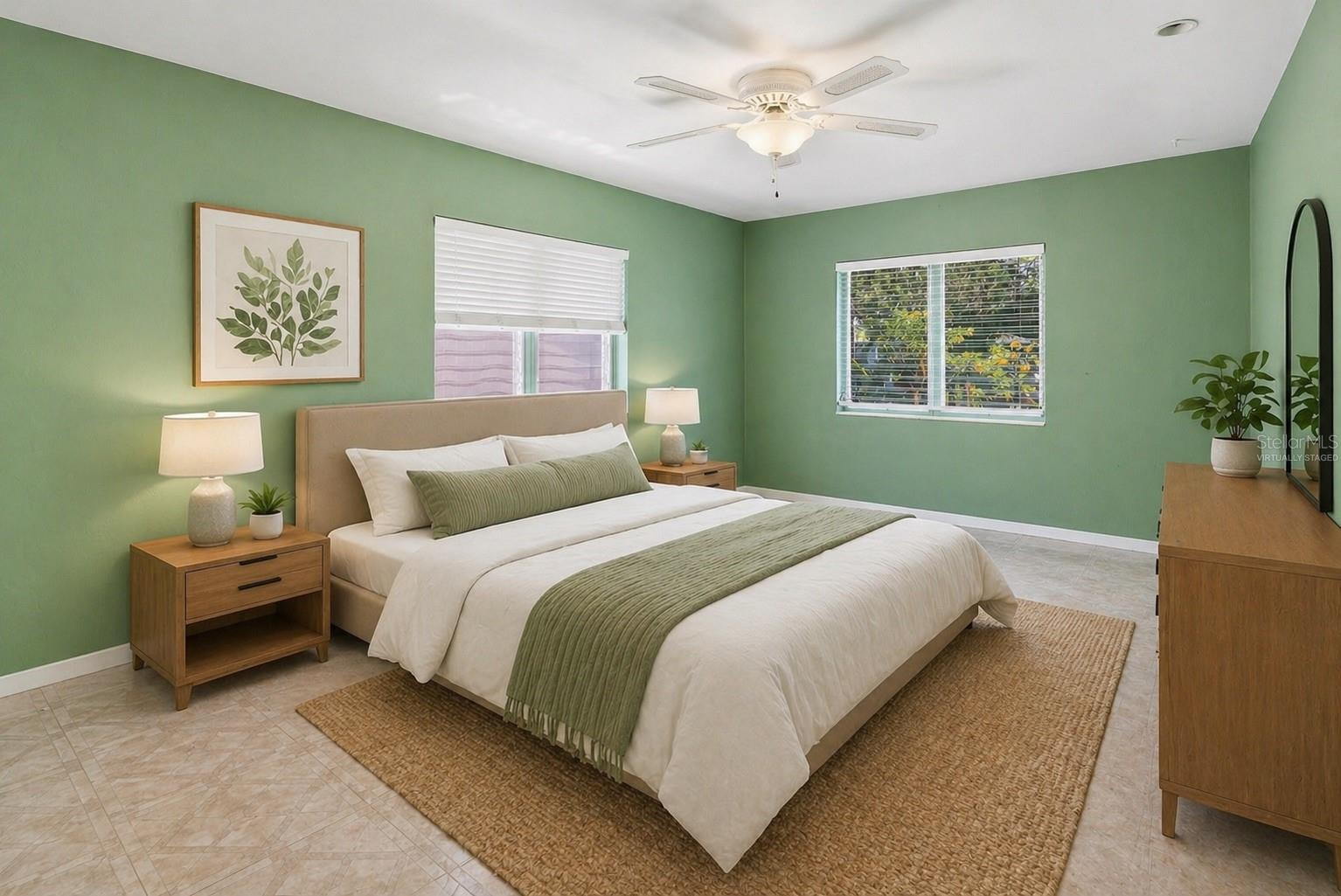 Spacious primary bedroom with two windows, beautiful natural light, and a walk-in closet. Virtually Staged