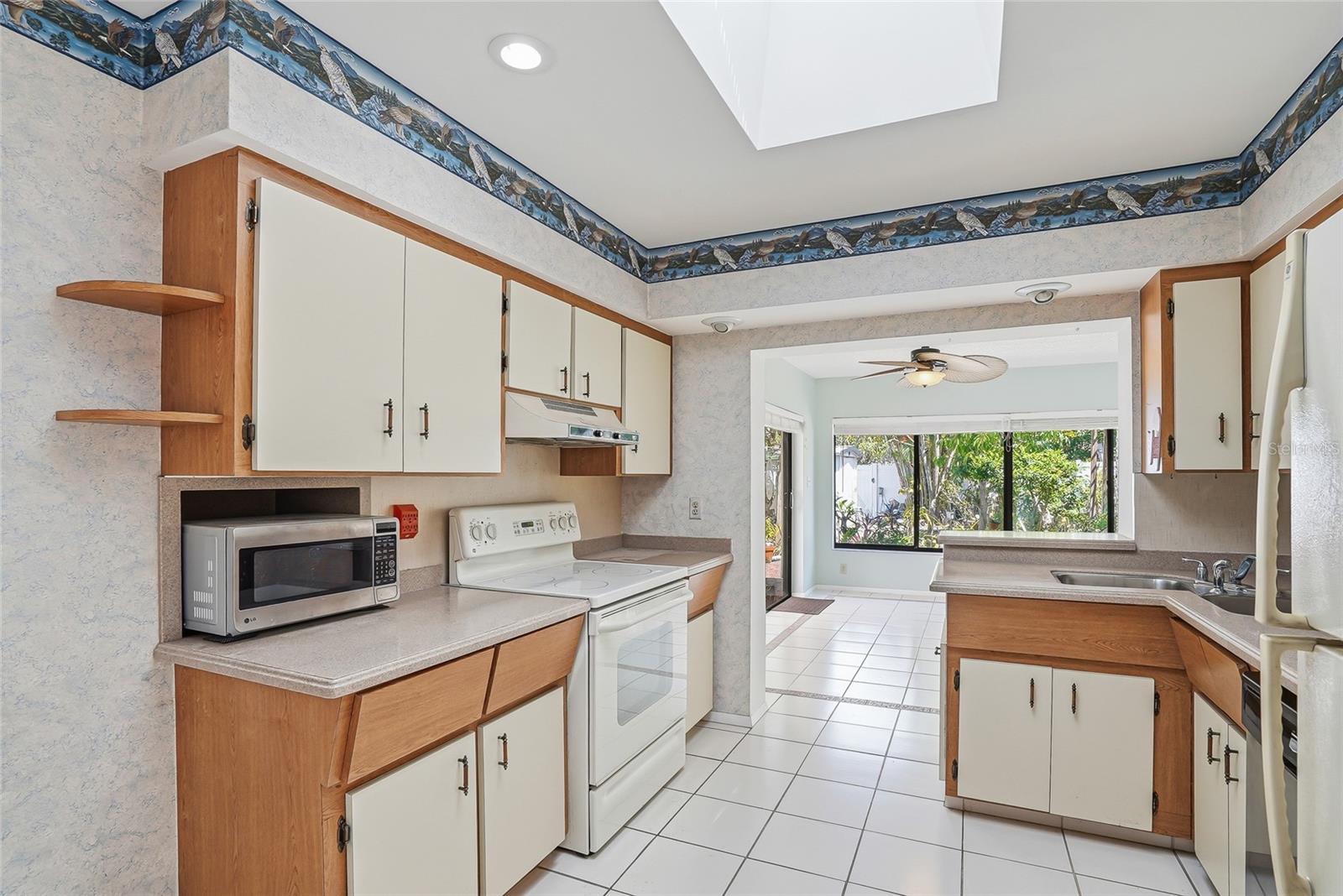 Kitchen conveniently connects to both the living and dining areas, making everyday life and entertaining easy.