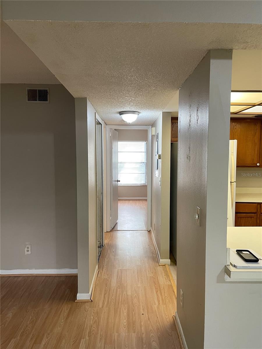 standing in family room looking down hall. Bathroom to the right, bedroom in front