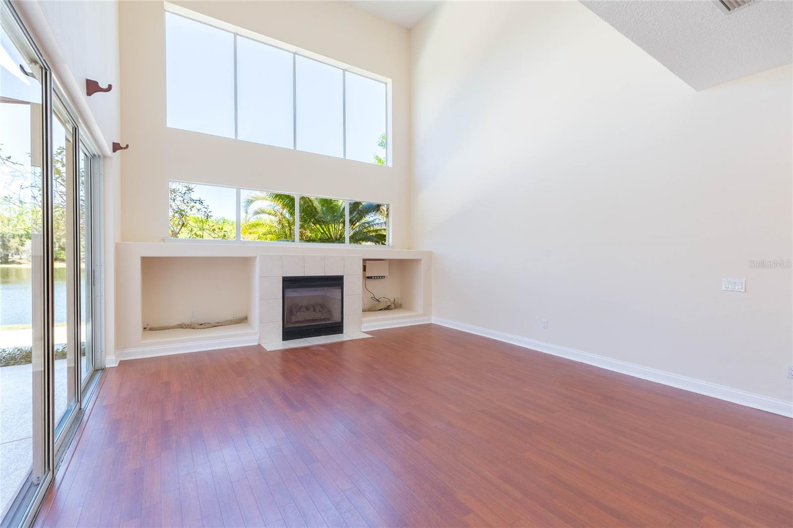 Great room has 22 foot ceilings, huge transom windows and fireplace