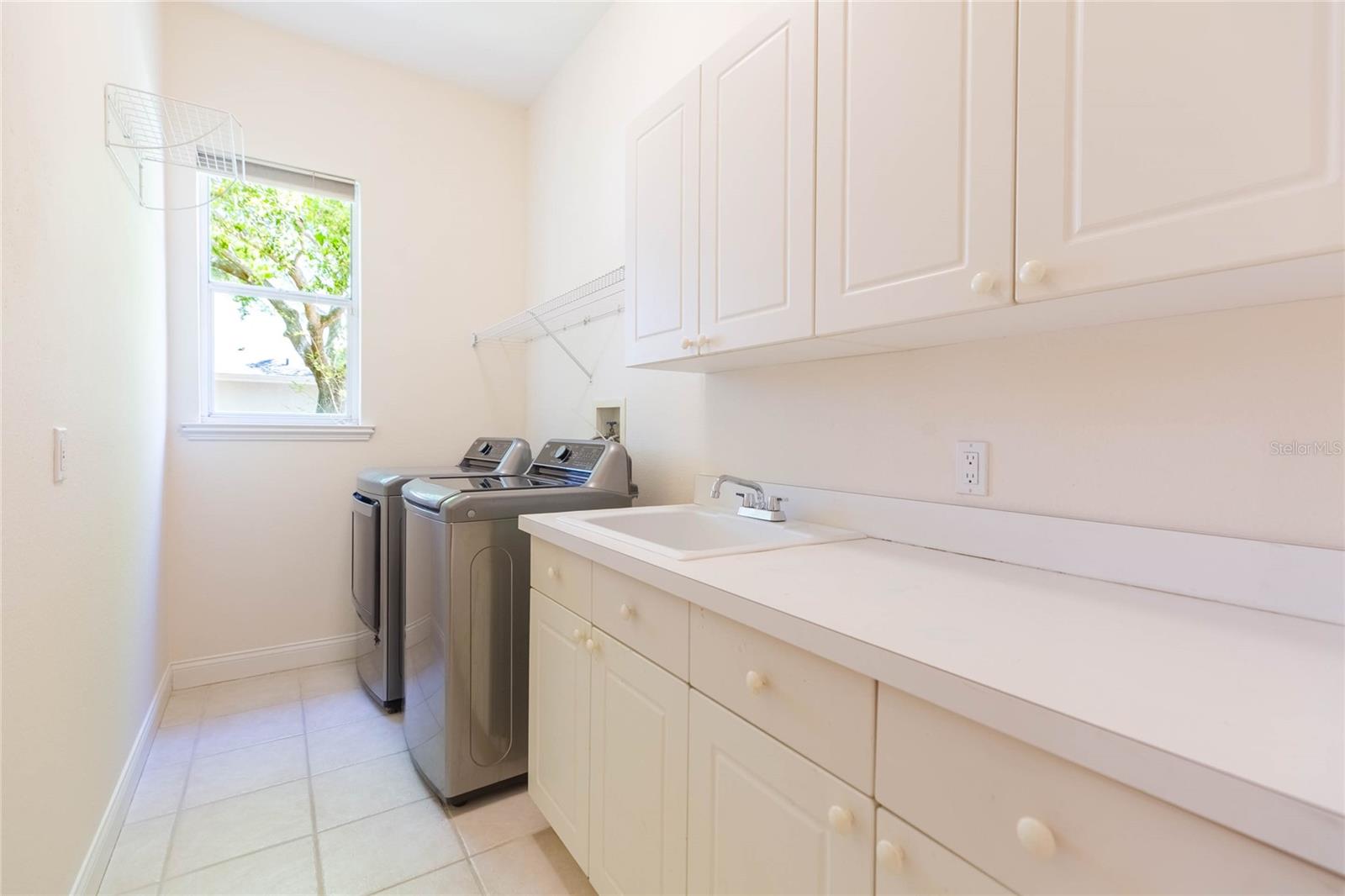 Large laundry room with additional storage
