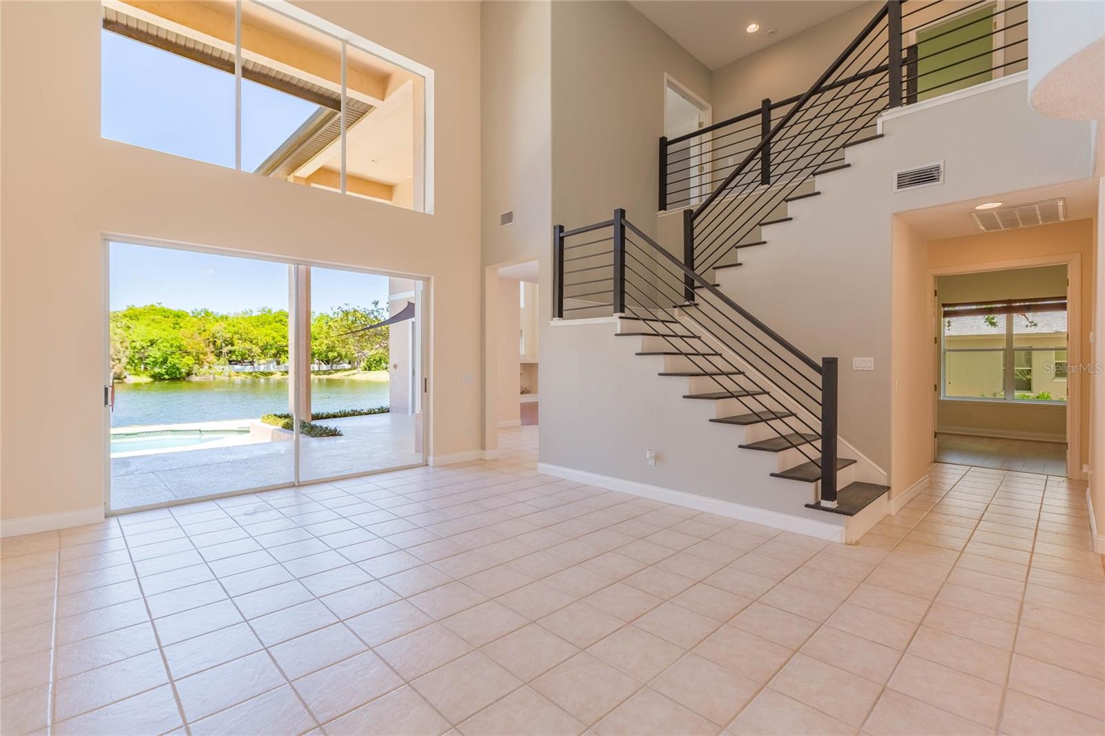 Formal living area with pool and lake beyond