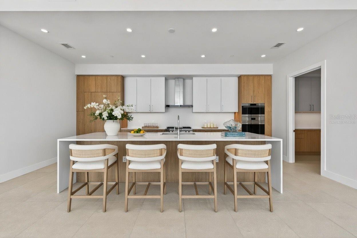 Virtually Staged- Kitchen W/ Wolf and Sub-Zero appliances, gas cooktop, double oven, and ample cabinetry.