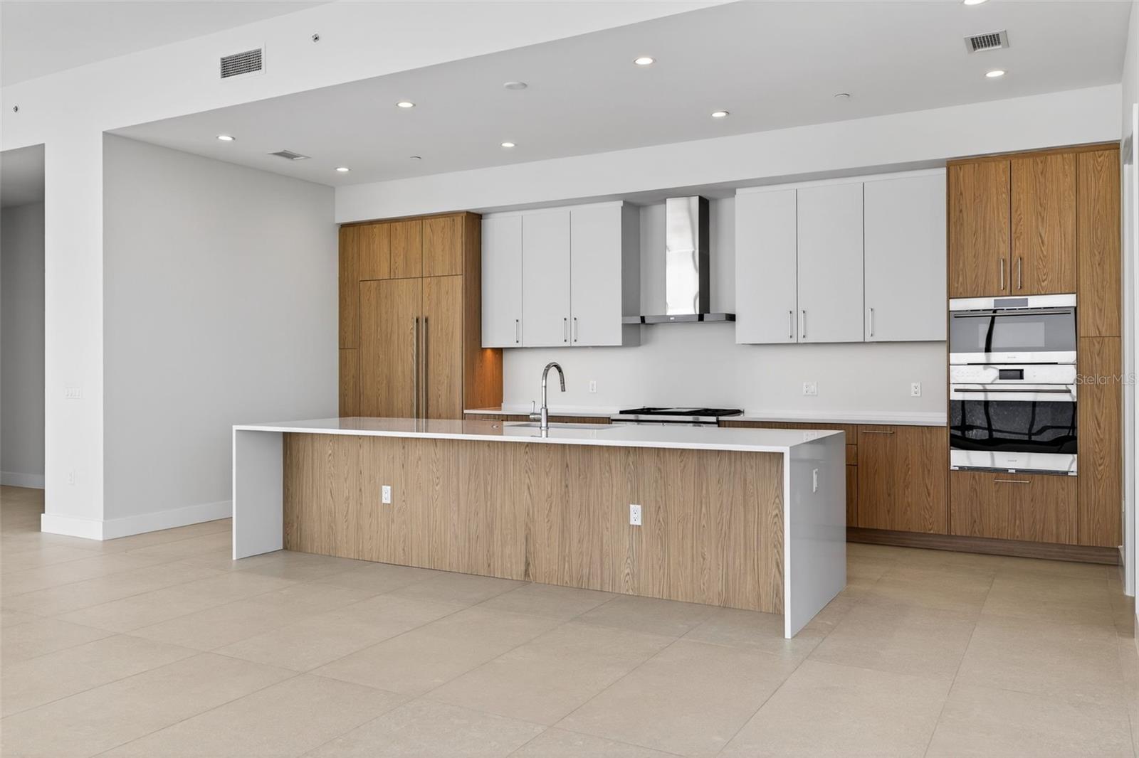 Kitchen W/ Wolf and Sub-Zero appliances, gas cooktop, double oven, and ample cabinetry.