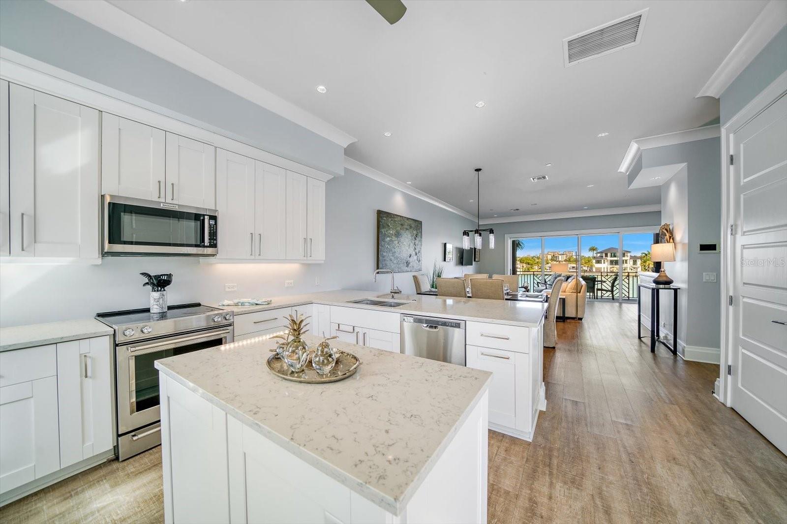 The second-level main living area boasts 10-foot ceilings and a spacious Great Room, showcasing serene intracoastal views through additional floor-to-ceiling sliding glass doors.