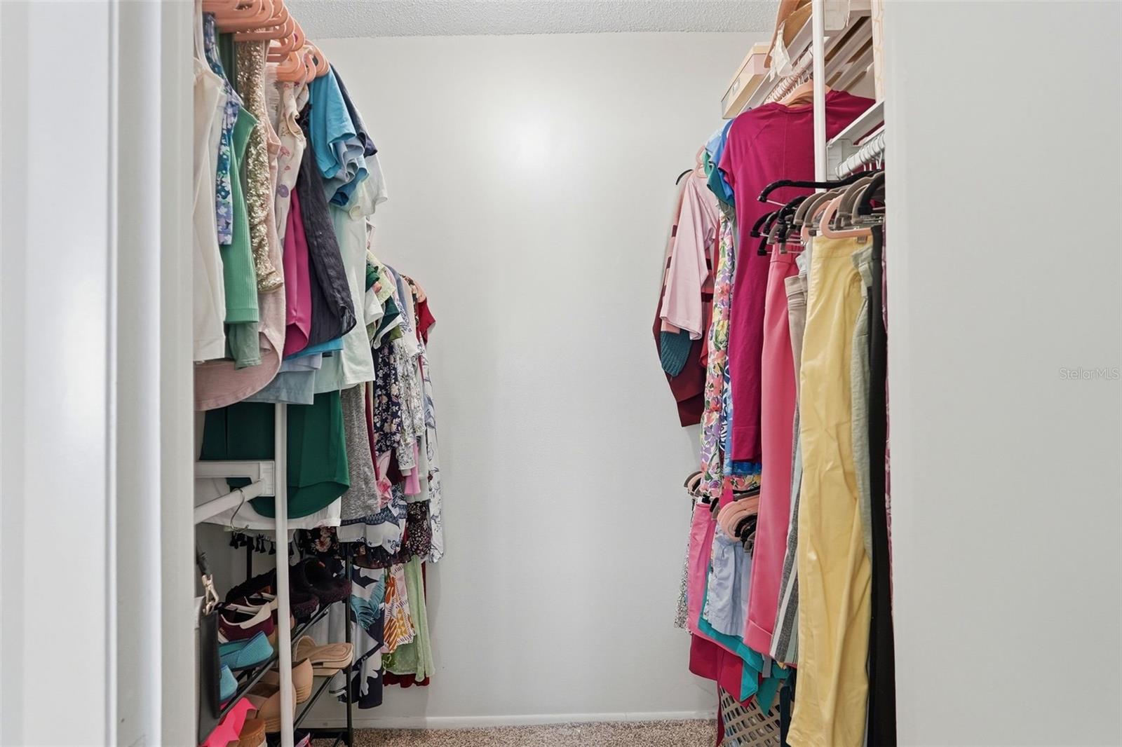 Walk in closet in the primary bedroom