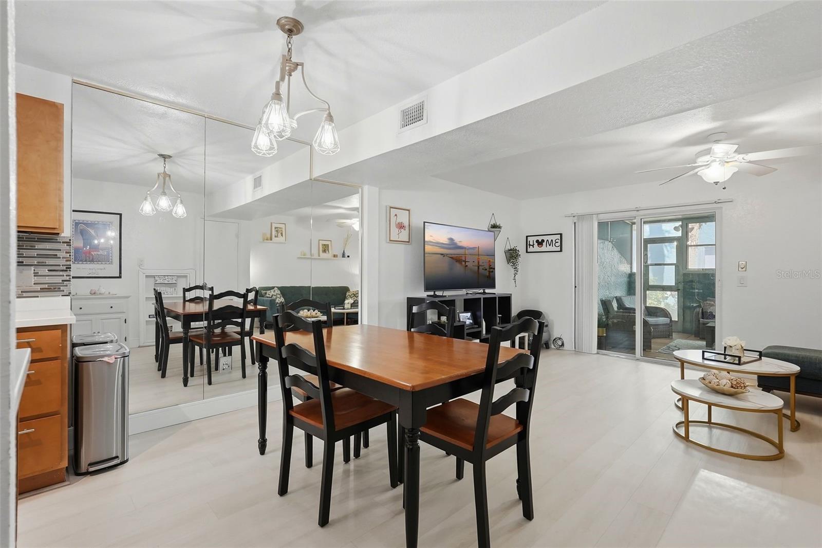Open living space looks even larger with mirrored wall in dining area