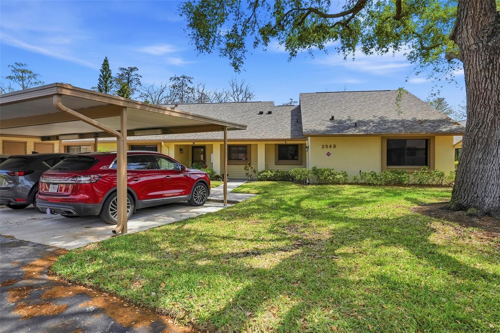 End unit, covered parking spot steps away from door