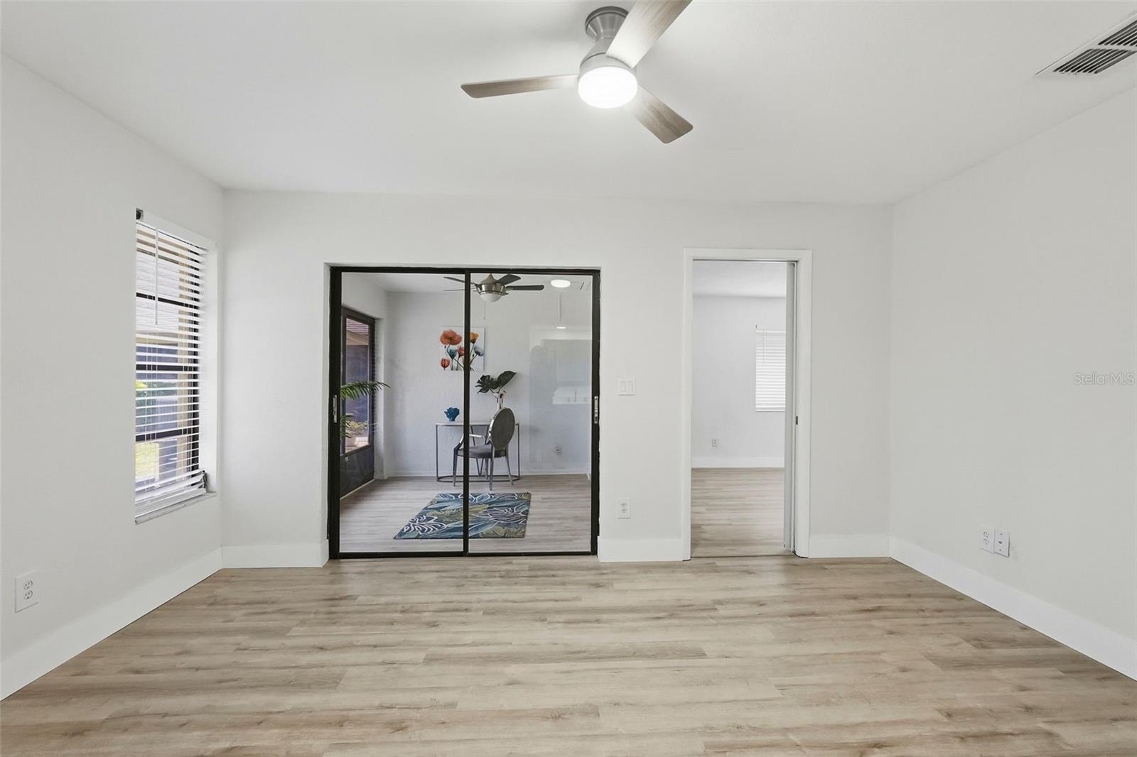 Primary bedroom overlooking sunroom