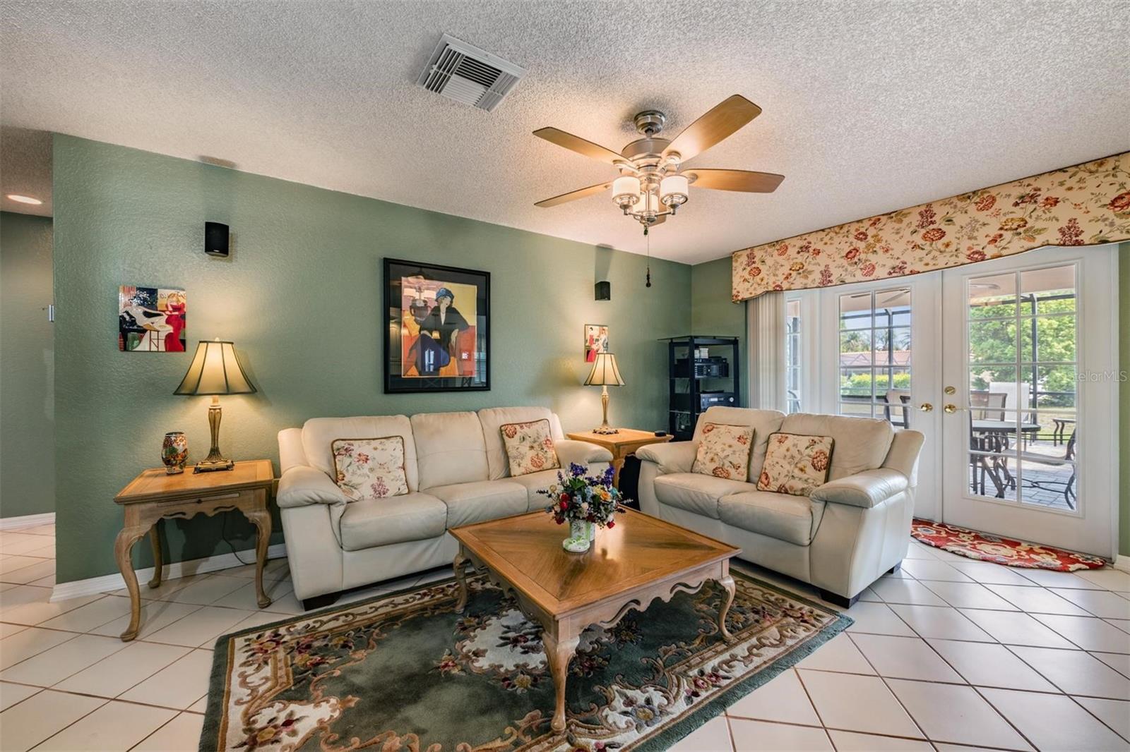 Family room Frencn doors to caged pool area