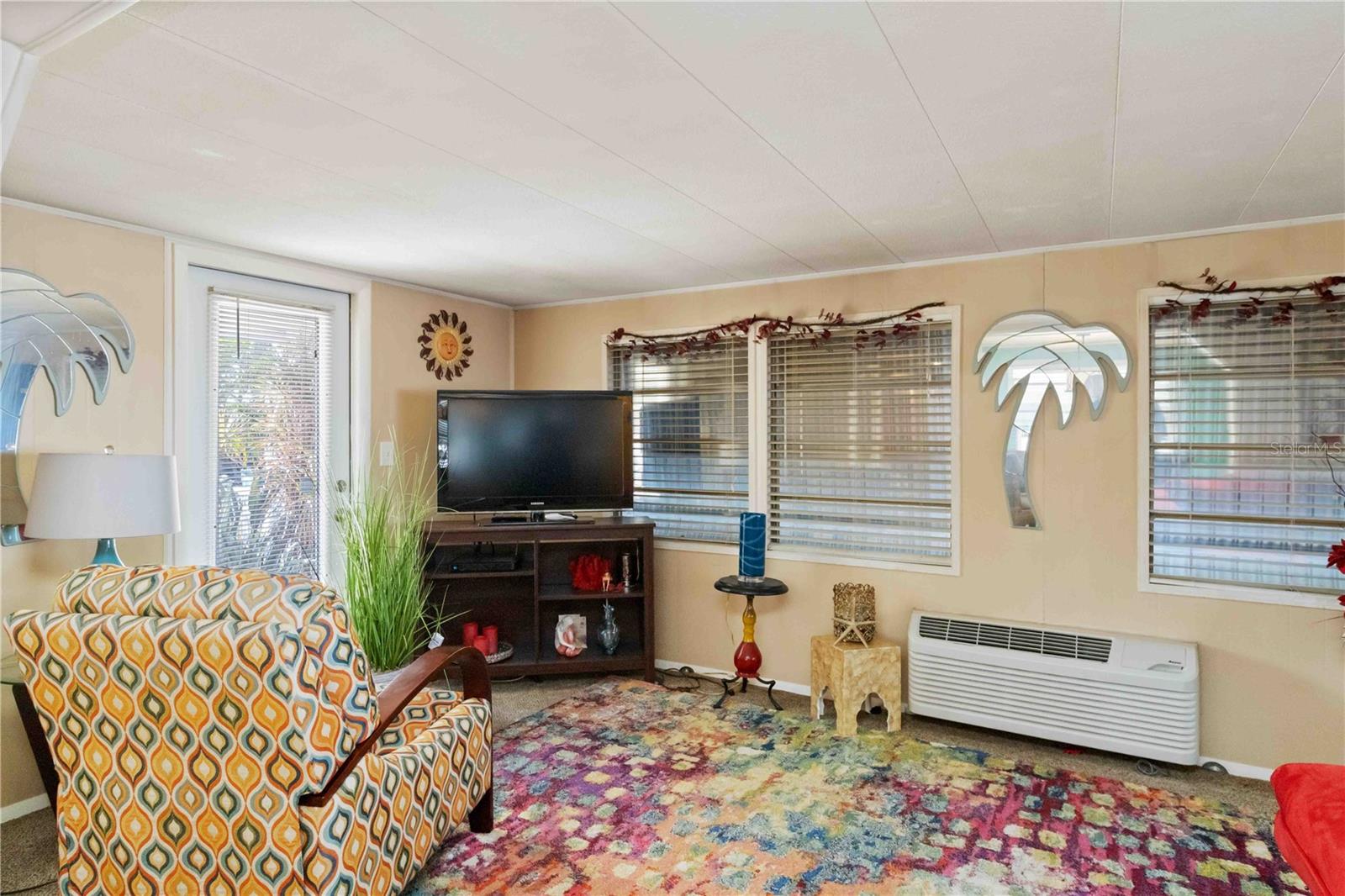 Lots of windows in the living room (storm shutters are currently down).