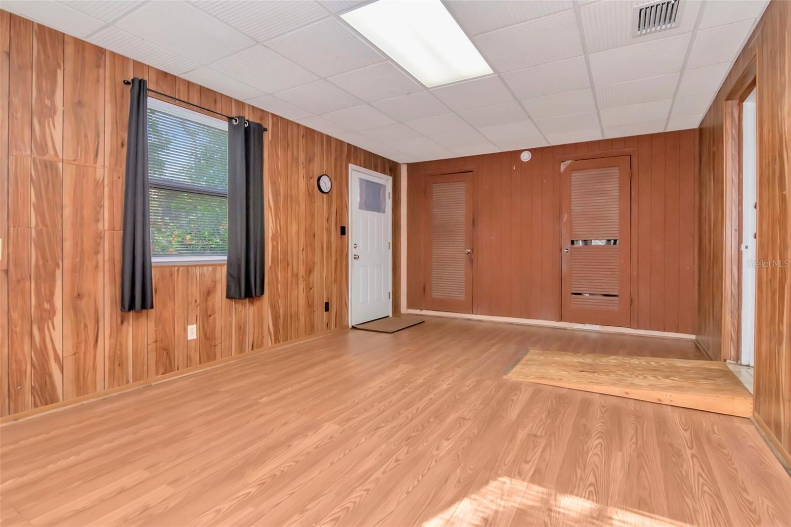 White door opens to the side of the home and the other 2 doors are laundry and storage room.