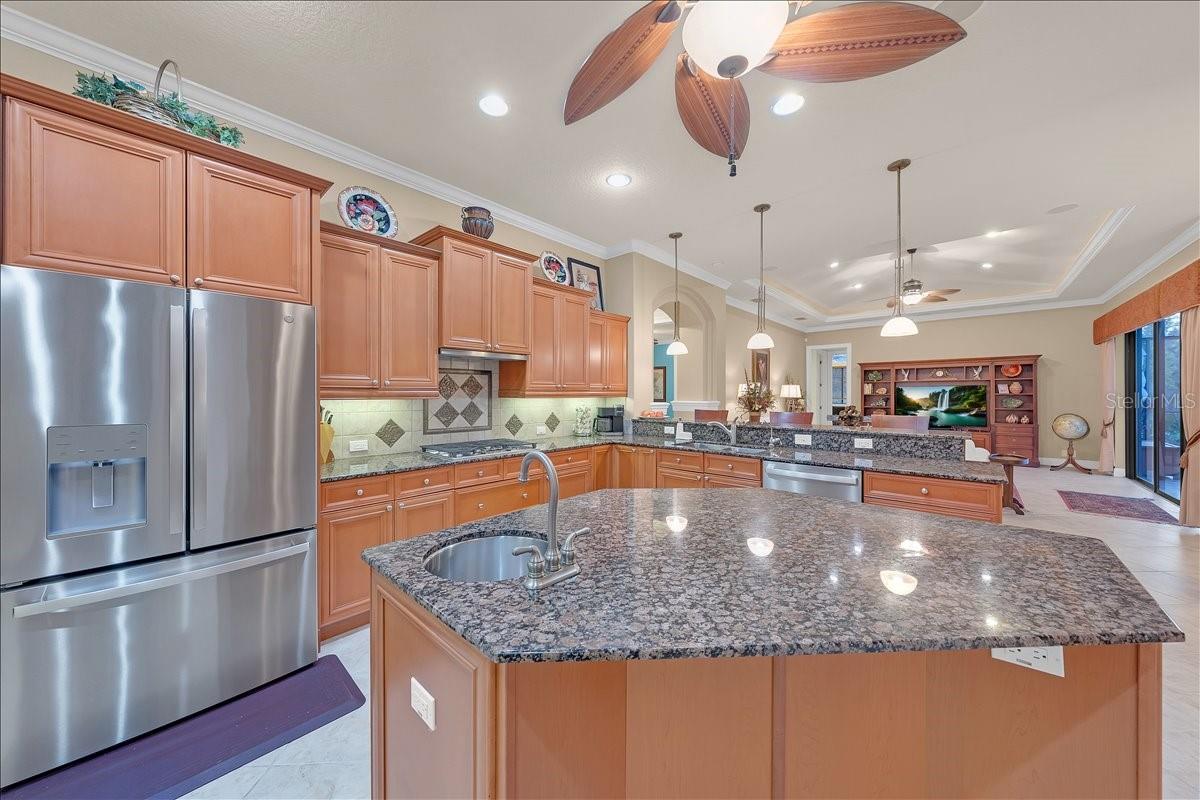 Beautiful kitchen boasting granite countertops, stainless steel appliances, and under cabinet lighting.