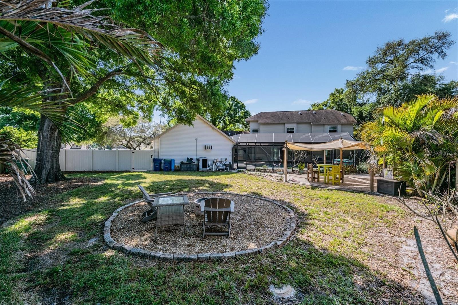 Firepit and view to rear of home - large fenced yard