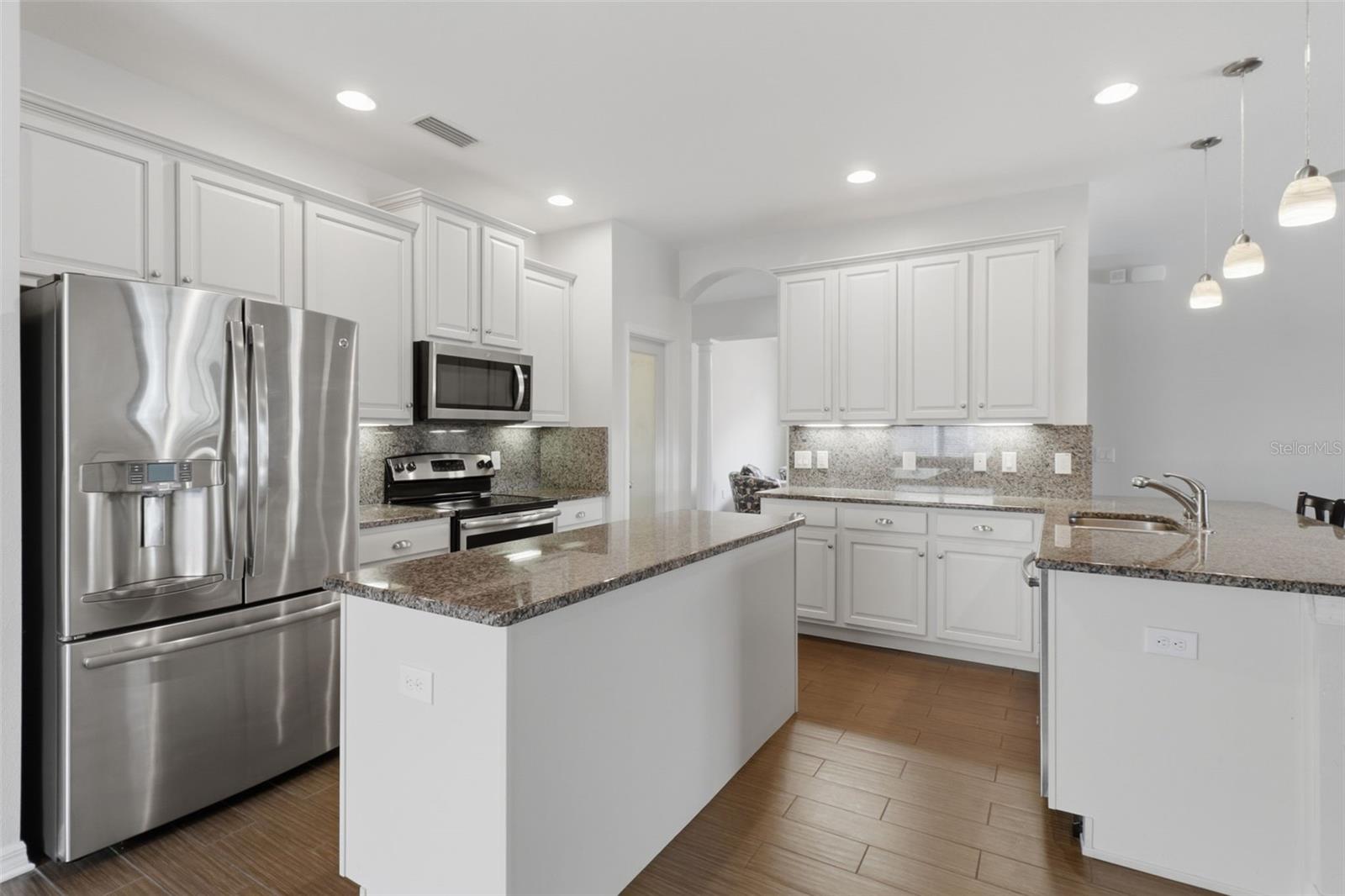 Open-concept design seamlessly connects the kitchen to the main living area, creating a bright and inviting space perfect for gatherings and comfortable daily living.