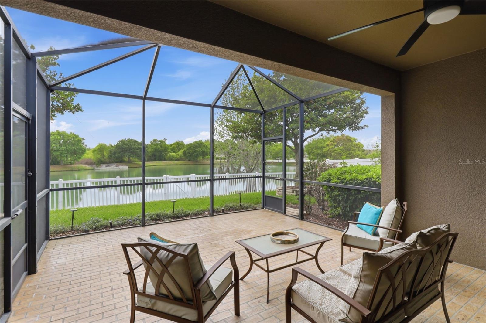 Spacious screened-in lanai with pavers, offering a seamless indoor-outdoor living experience. Enjoy peaceful waterfront views and a private, fully fenced backyard—perfect for relaxing or entertaining year-round.