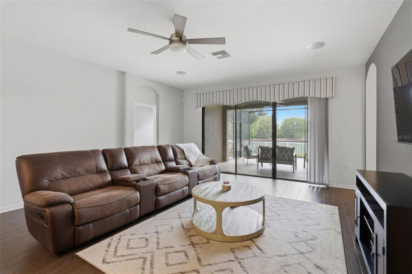 Spacious living area filled with natural light and direct access to the screened lanai, creating a seamless indoor-outdoor living experience with beautiful waterfront views.