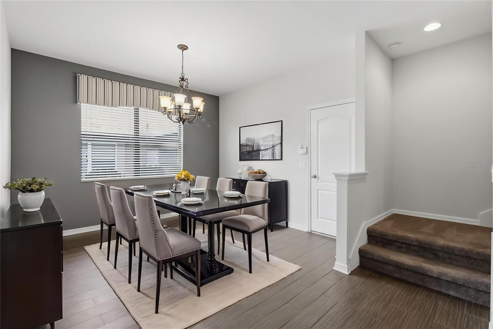 Dedicated dining space with modern lighting and ample room for hosting, conveniently located near the kitchen and main living areas.