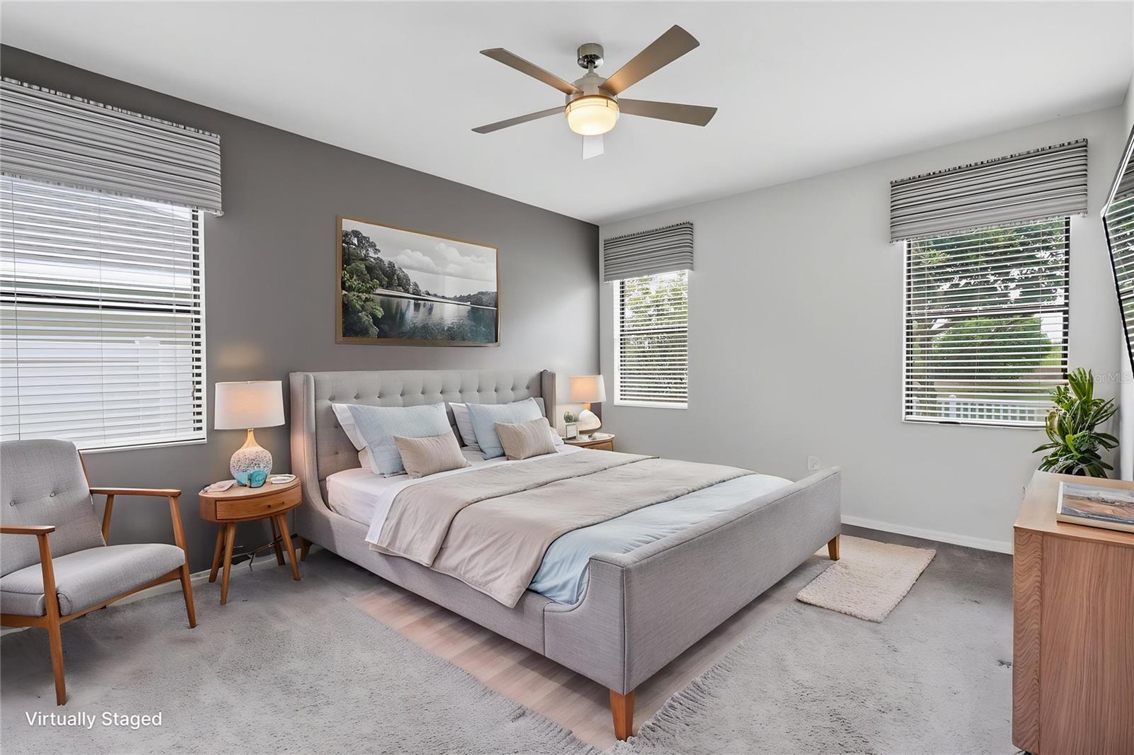 Spacious primary suite featuring abundant natural light, custom window coverings, and a thoughtfully designed layout, creating a comfortable and private retreat.