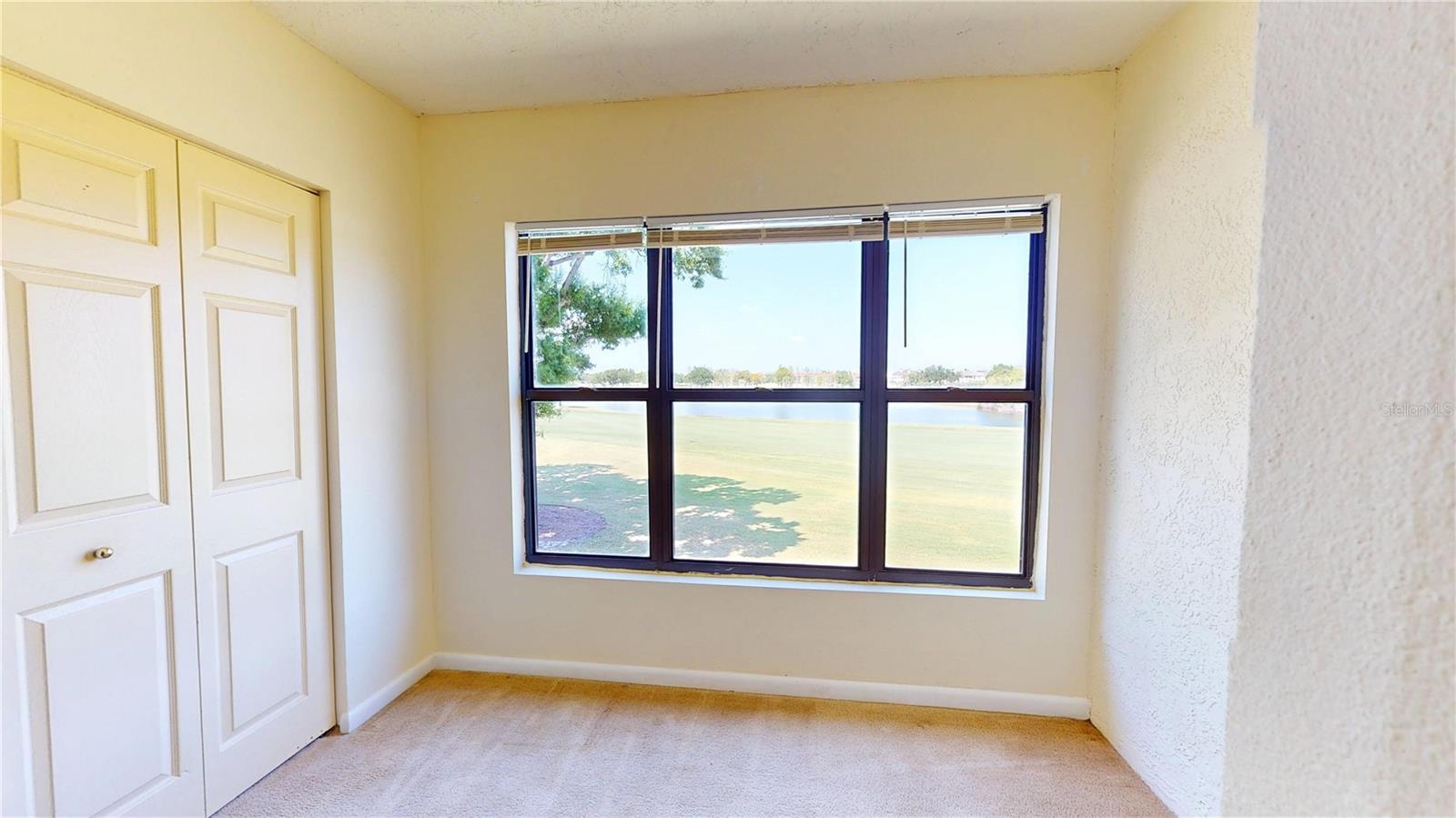 Master Bedroom with one of the Closets and Bonus Space with Lake & Golf Course Views