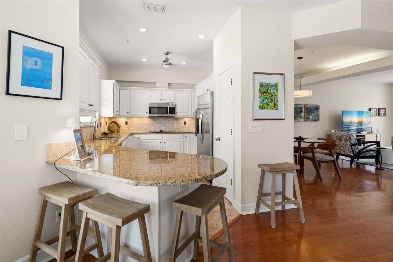 The heart of the home offers a seamless blend of style and function, from the wrap-around breakfast bar to the sun-drenched eat-in nook.