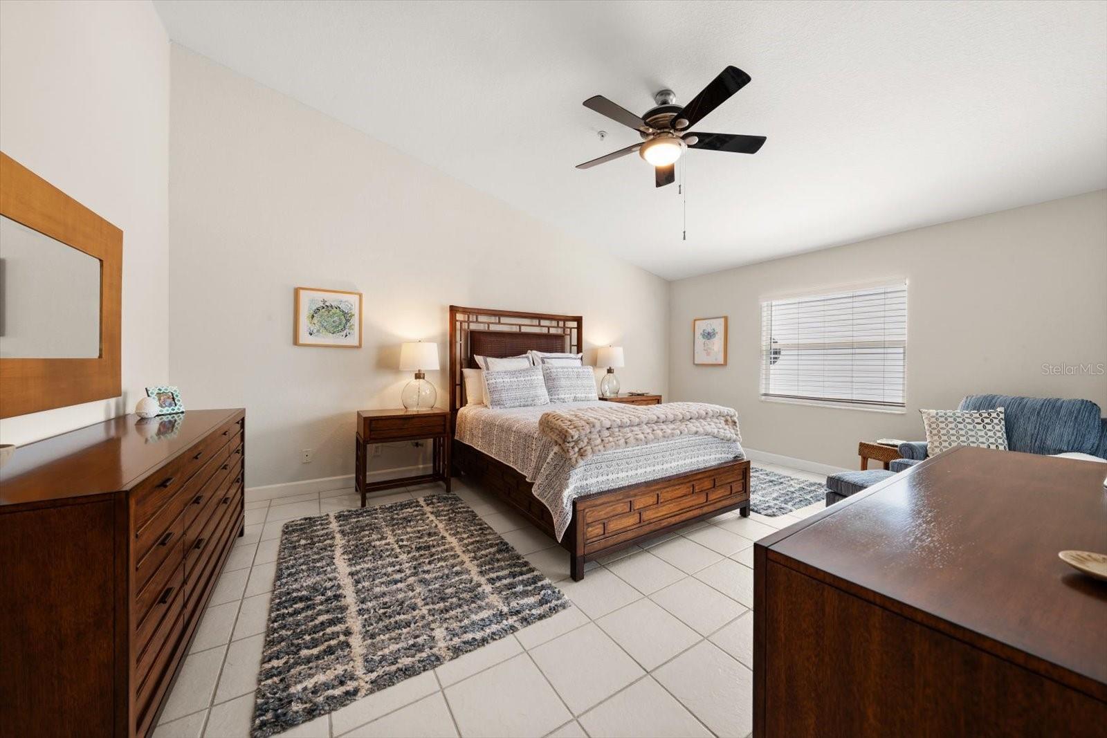 Soaring ceilings and a private terrace with Gulf glimpses define this top-floor primary sanctuary.