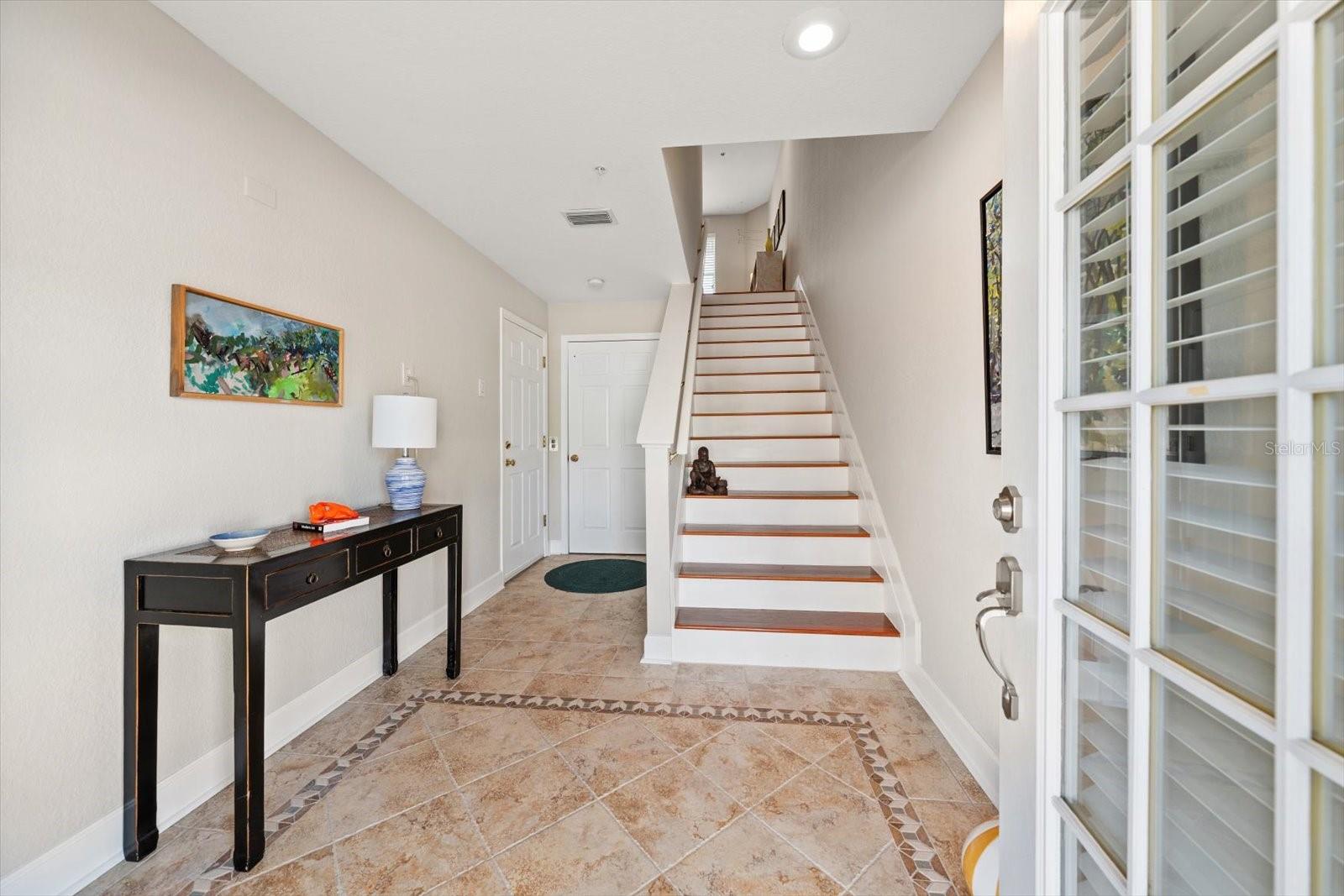 The ground level foyer is inviting with elegant hardwood flooring, and the convenience of an elevator that services all levels.