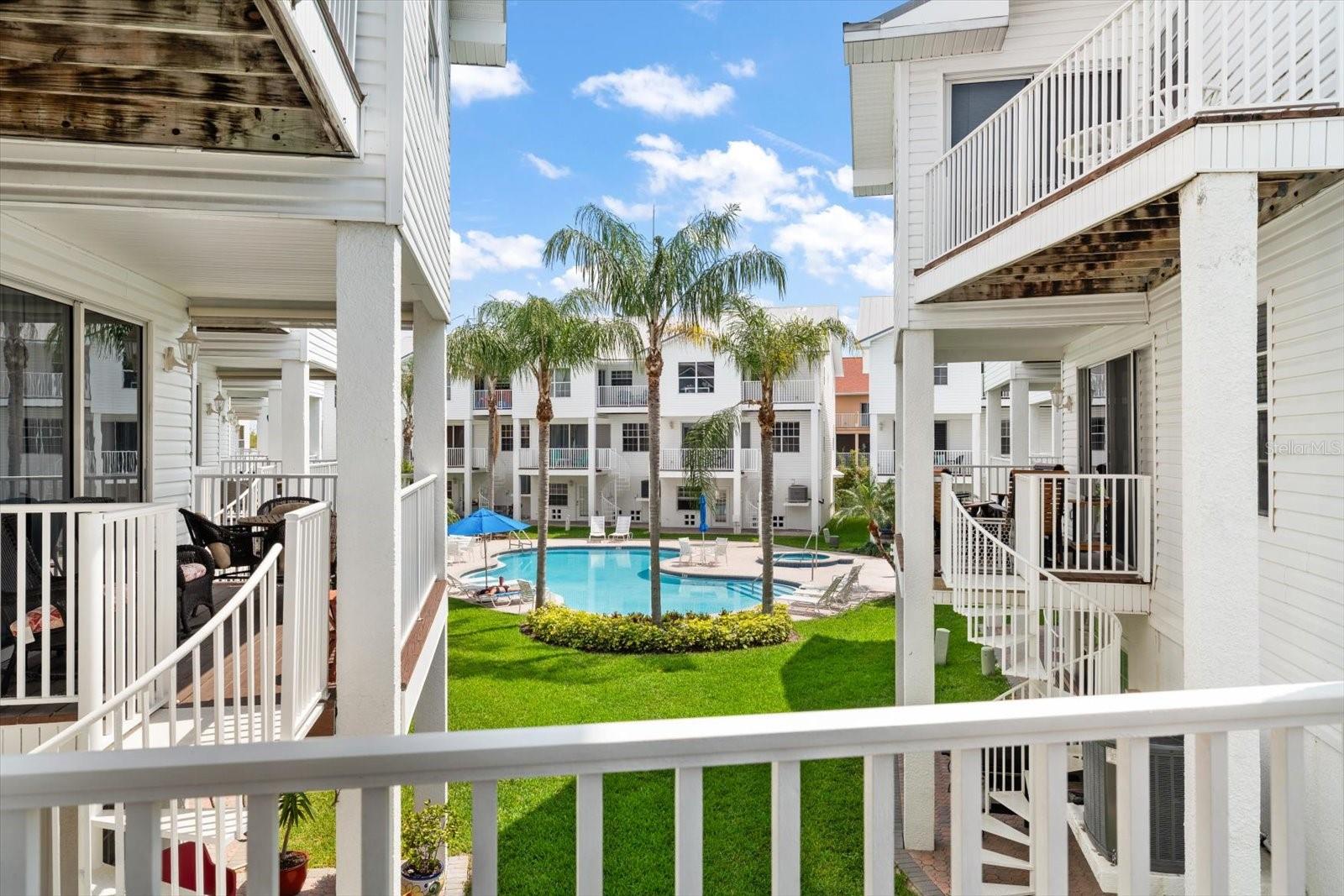 Several outdoor living areas complement this remarkable residence. A spacious terrace from the great room with stairs, leads to the ground level and pool area.