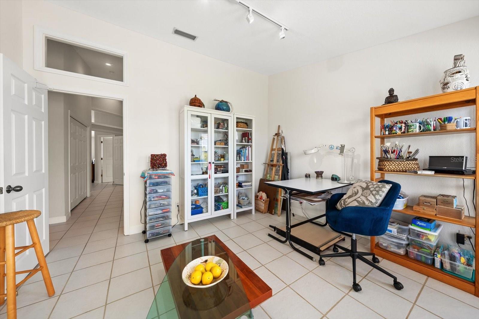 Guest bedroom number three, currently used as an art studio, provides a versatile space for a bedroom, office, or hobby room.