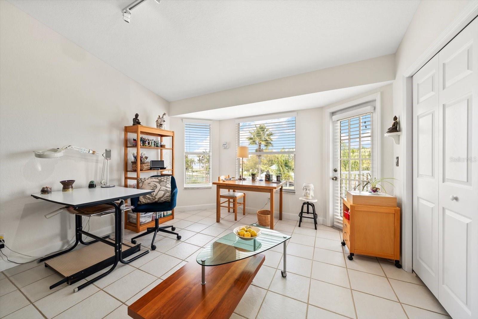 Guest bedroom number three offers loads of natural light and access to the shared balcony.