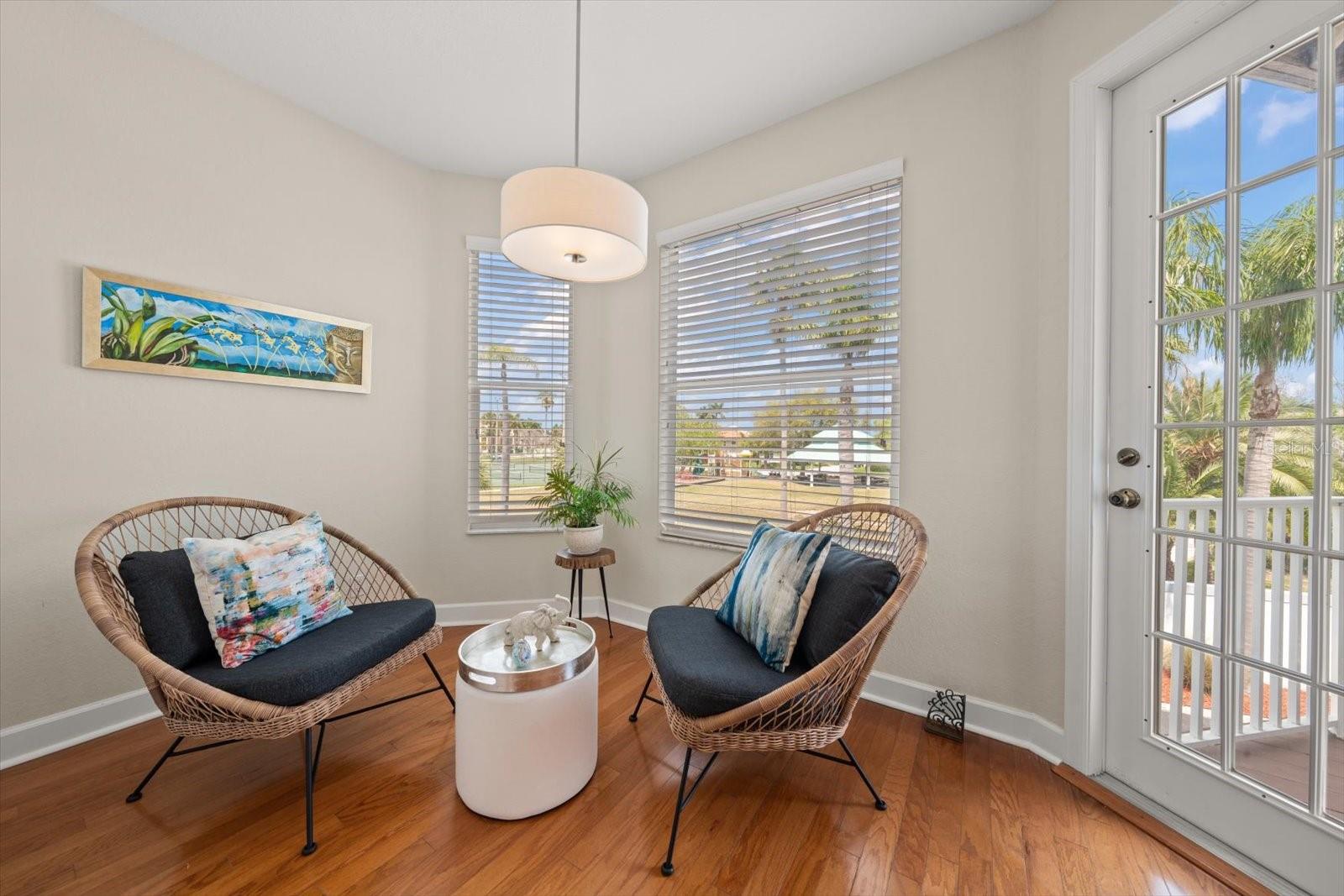 Charming breakfast nook bathed in natural light and leading to a private balcony.