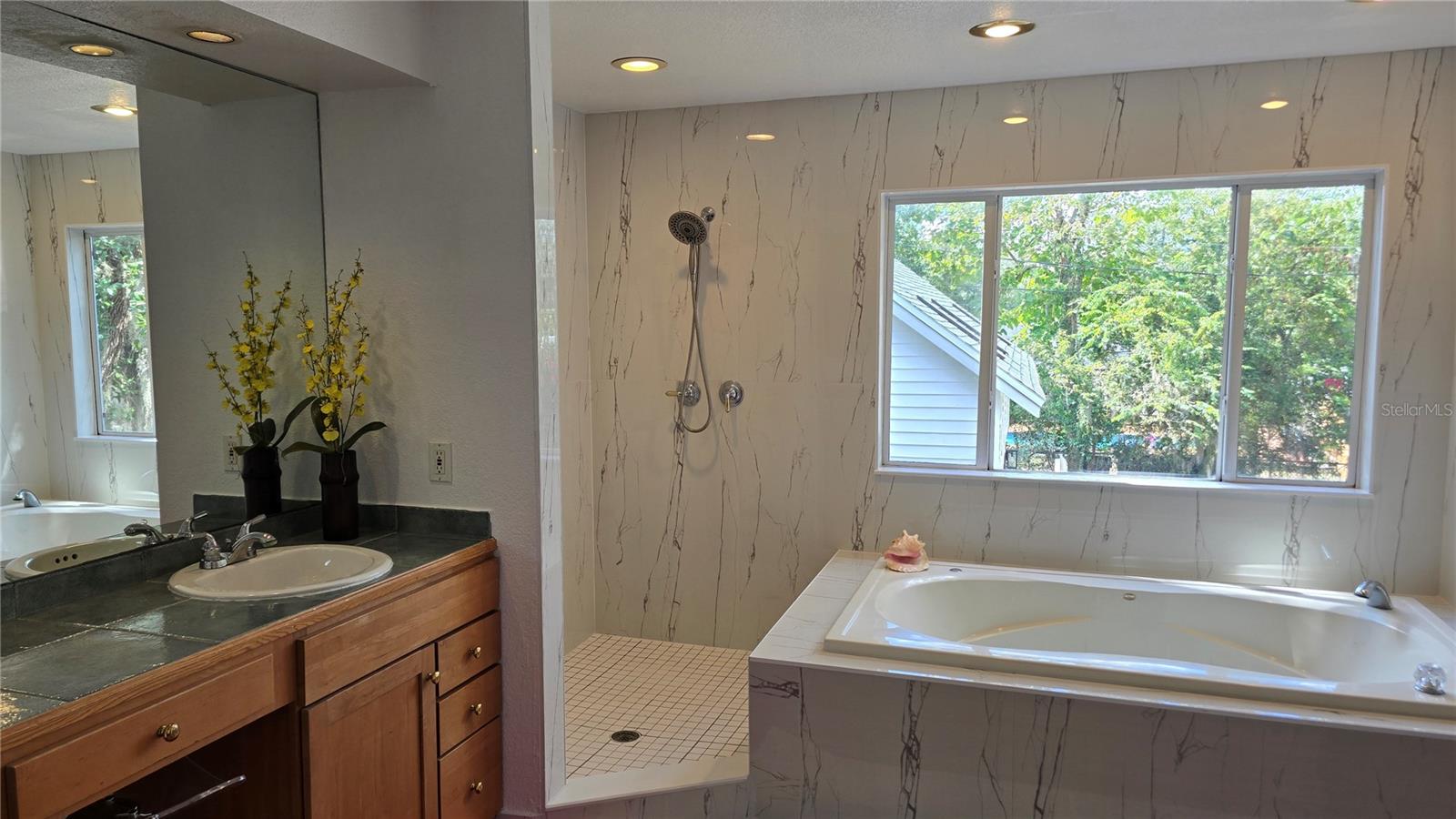 Primary bathroom dual sink. Jacuzzy tub