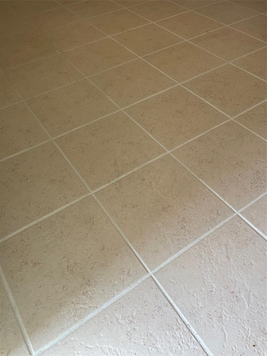 New tile flooring throughout, square in bedroom, wood plank look in living area