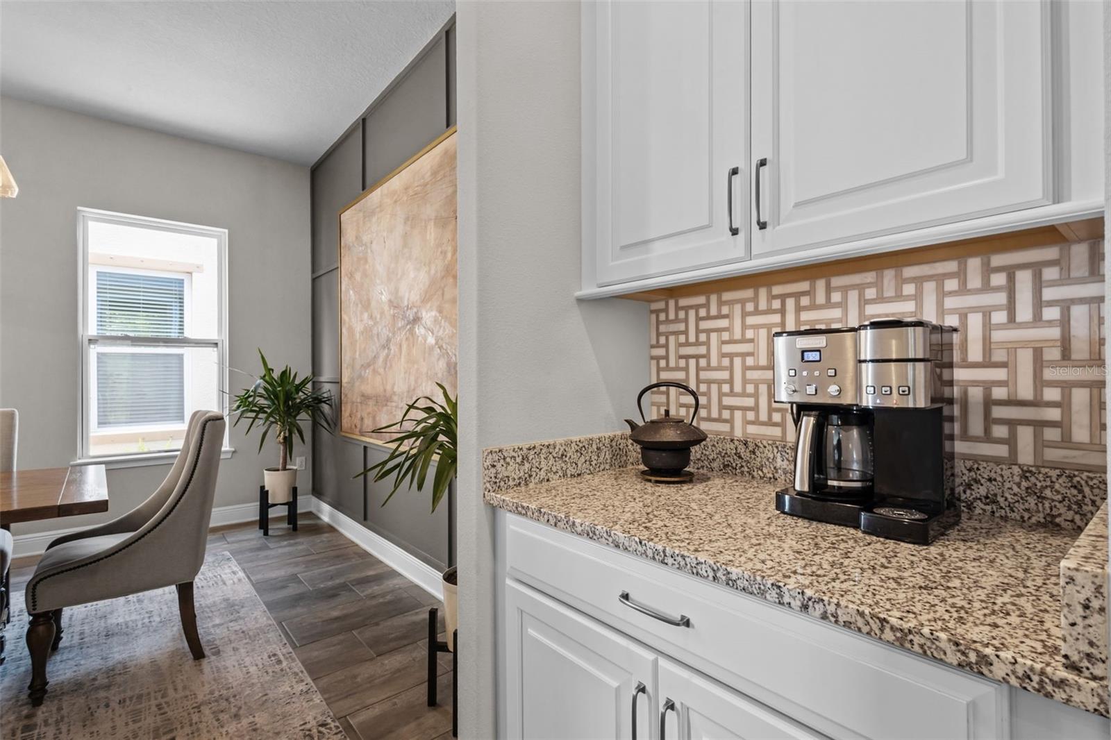 Butlers pantry area with additional counter space and cabinetry