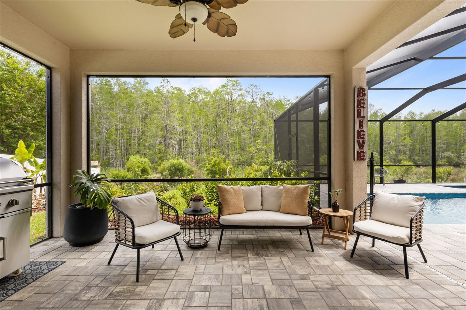 Expansive screened lanai designed for outdoor living and entertaining.