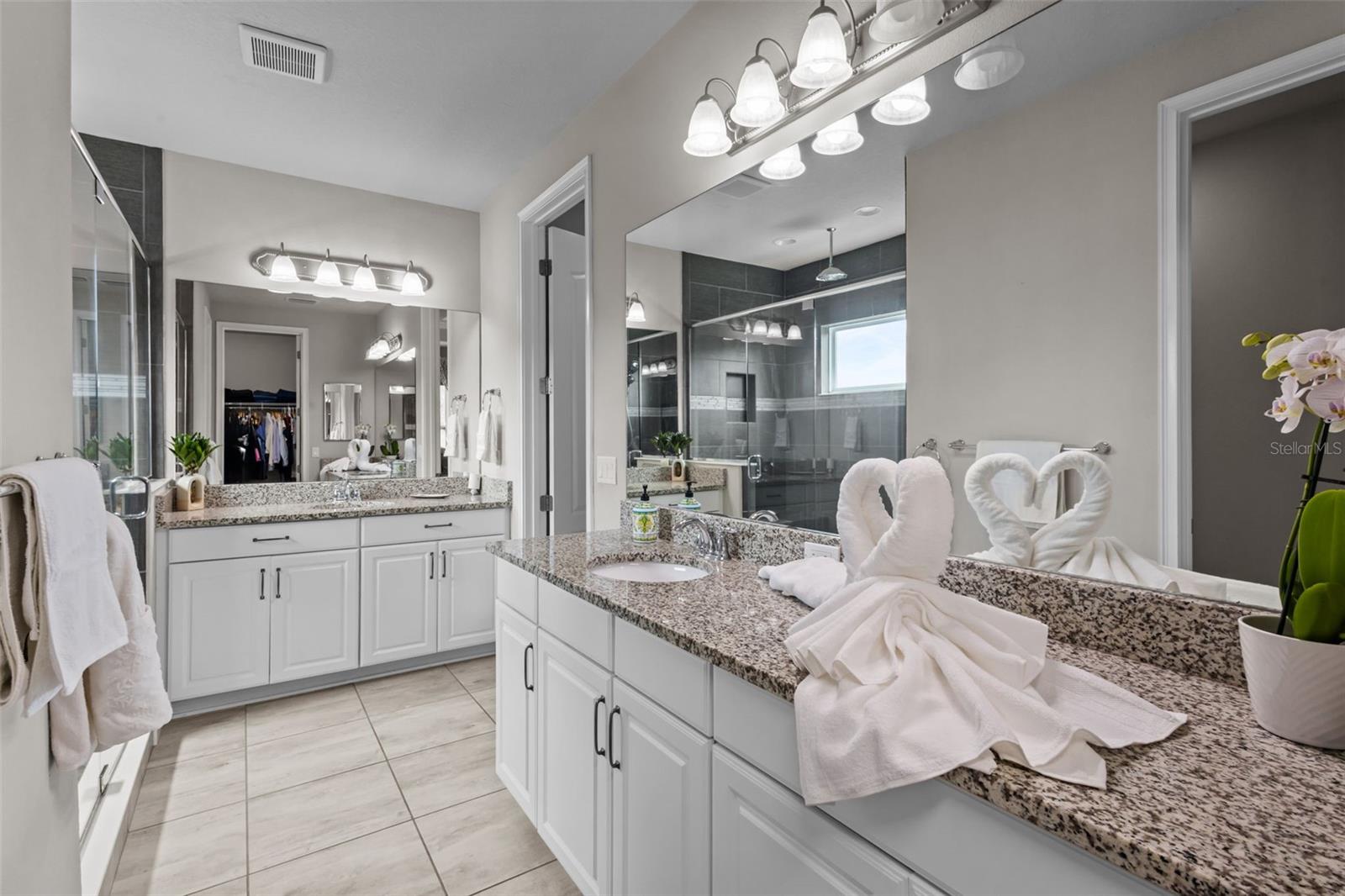 Primary bathroom with dual sinks and a well-designed layout.
