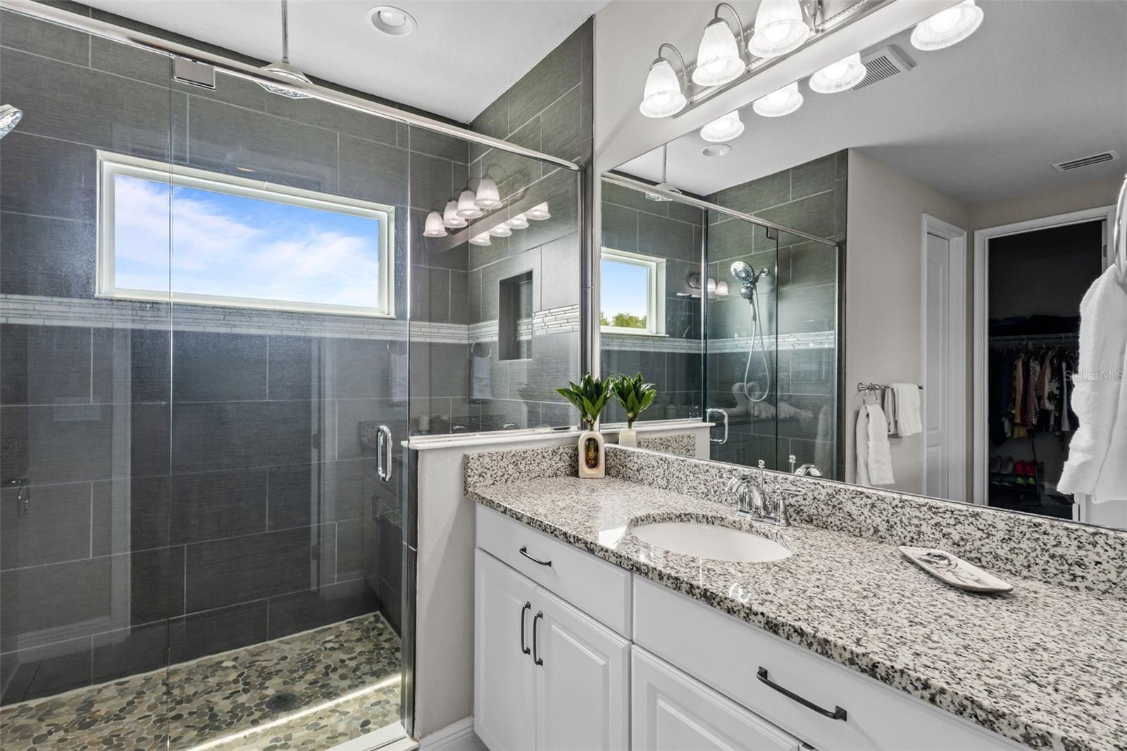 Primary bathroom with dual sinks and a well-designed layout.