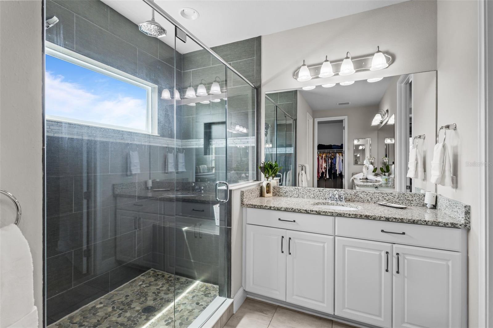 Primary bathroom with dual sinks and a well-designed layout.