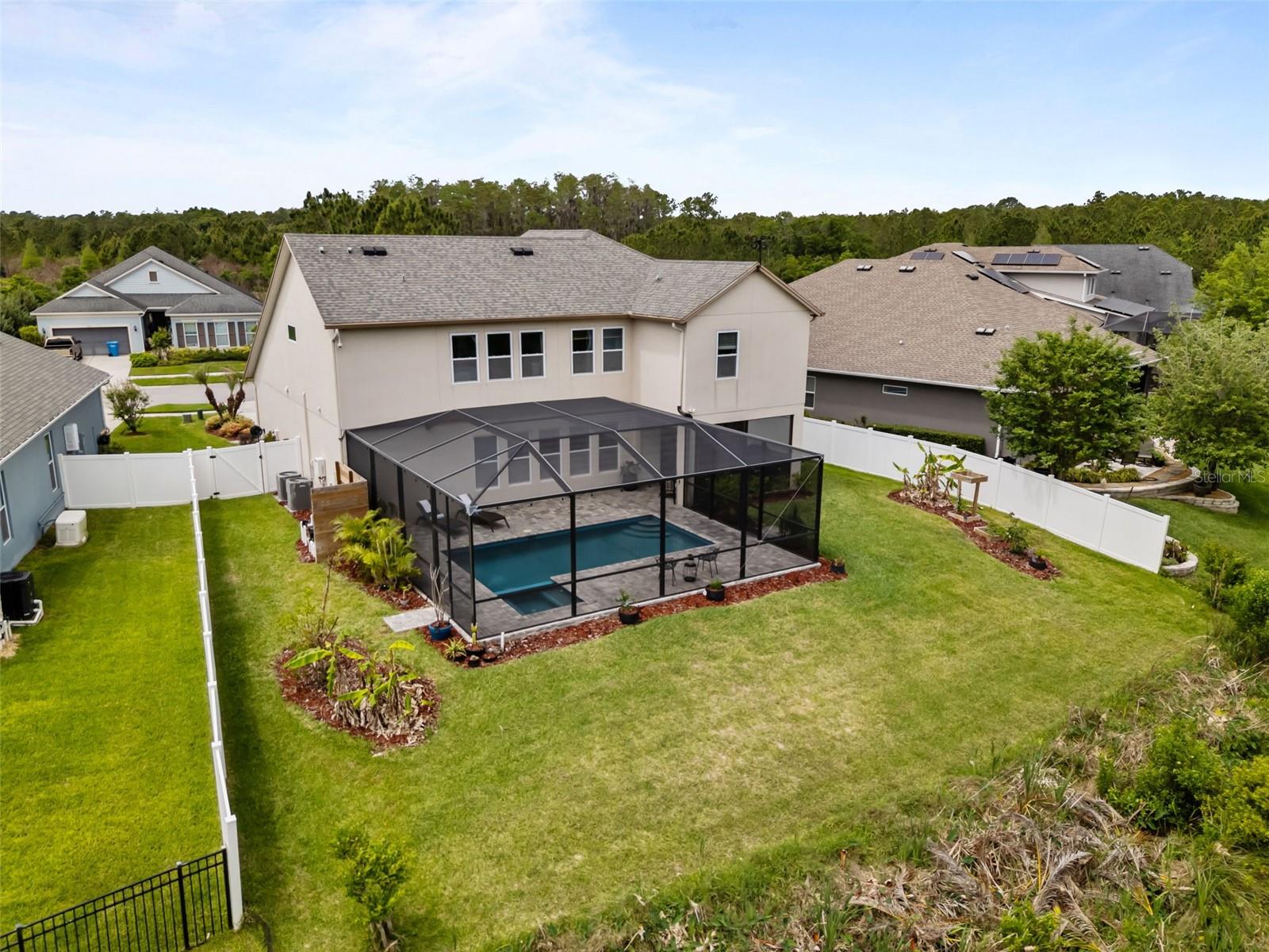 Aerial view highlighting the conservation lot and private backyard.