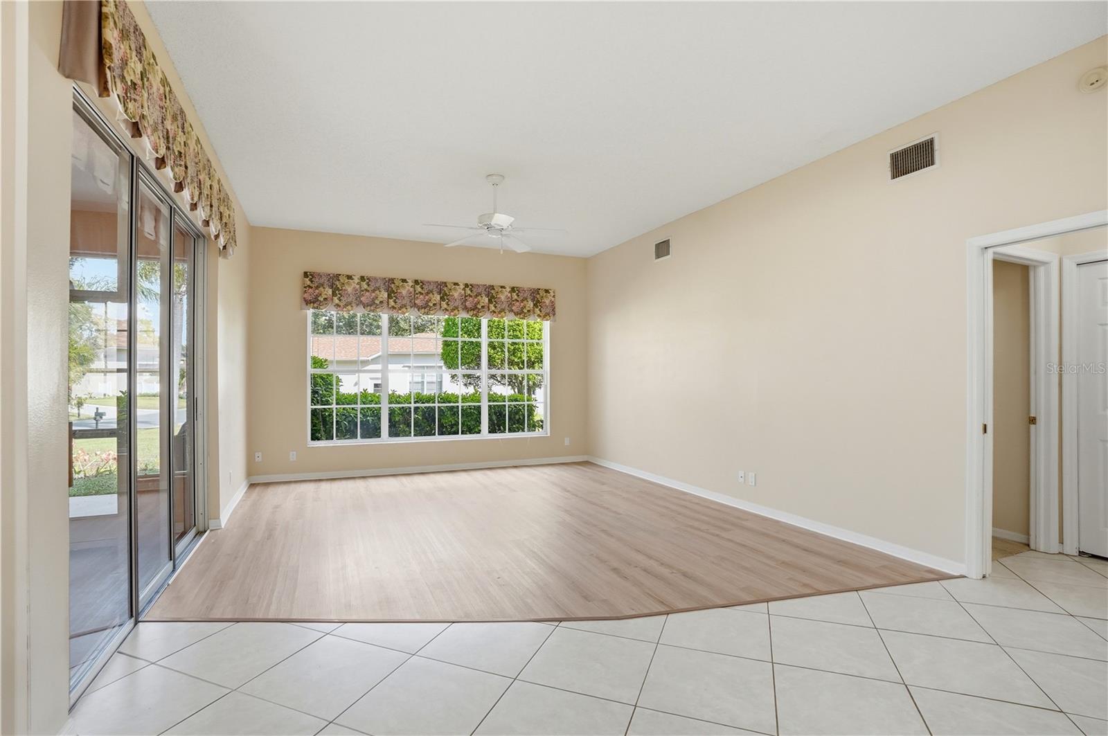 Living room, full of natural light. Overlooks the backyard and has an extra large sider to access the lanai.