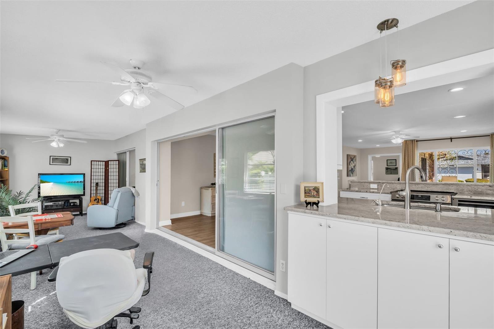 Kitchen passthrough window to the Florida Room with additional built-in cabinetry & lighting~